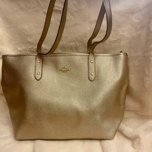 Gold Coach Over-the-shoulder Tote bag.